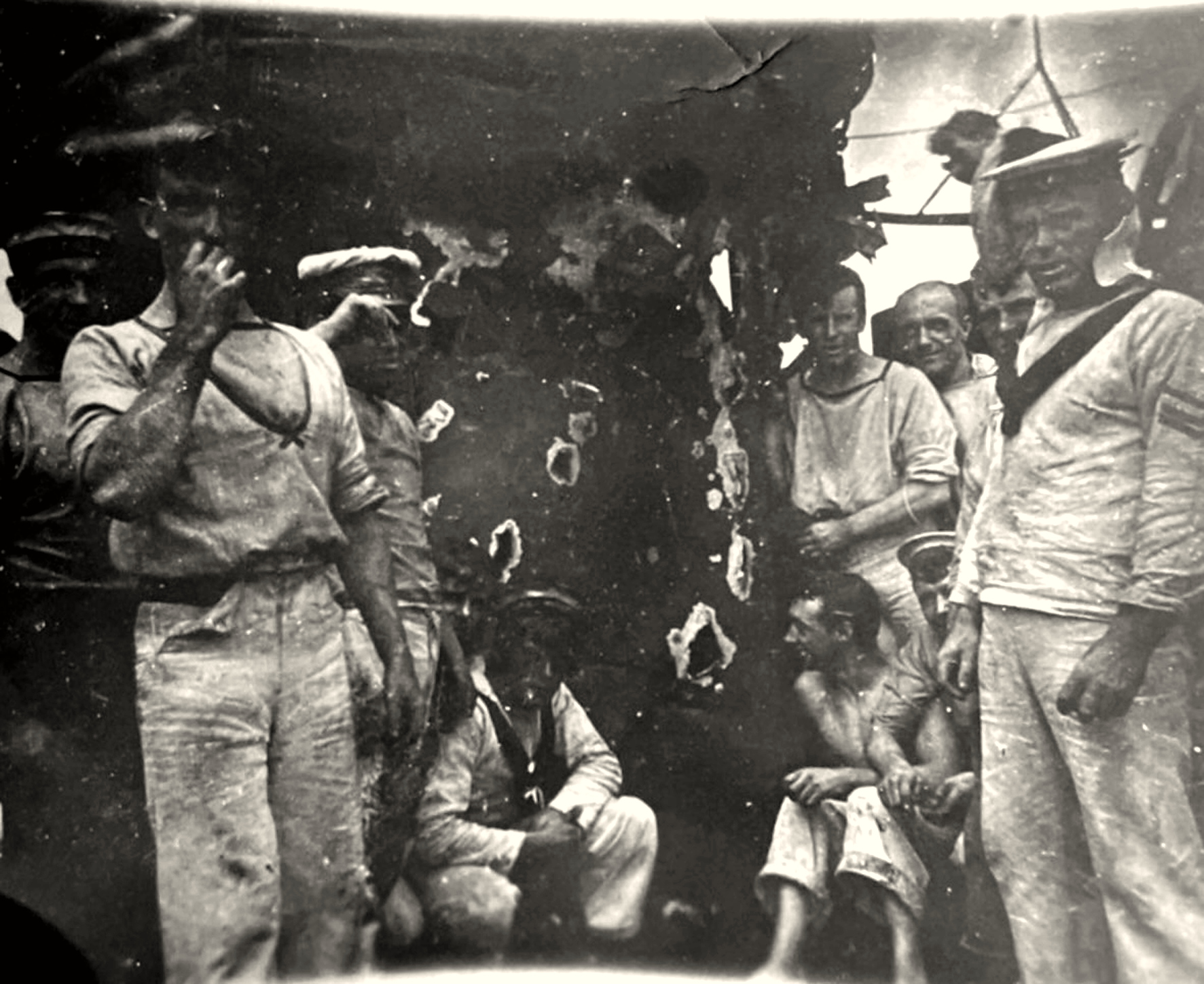 HMAS Sydney sailors beside shell holes in the aft control station