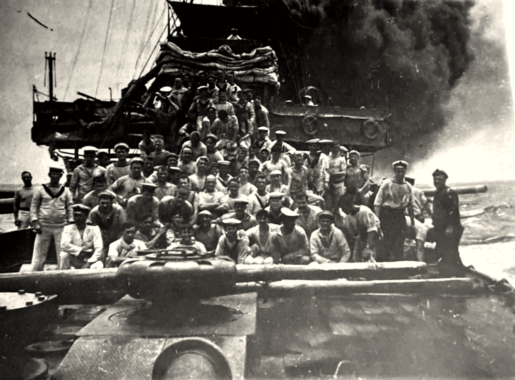 HMAS Sydney sailors gathered around a gun after the engagement