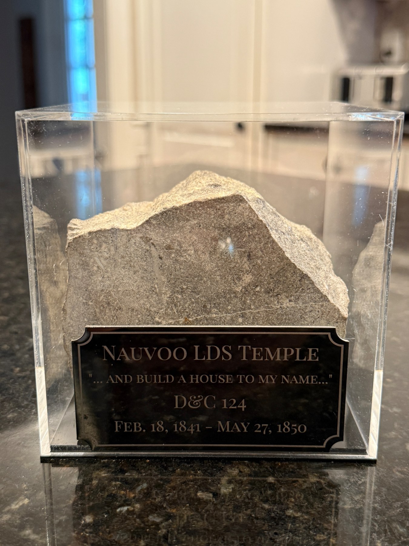 Limestone block displayed with a plaque identifying it with the original Nauvoo LDS Temple