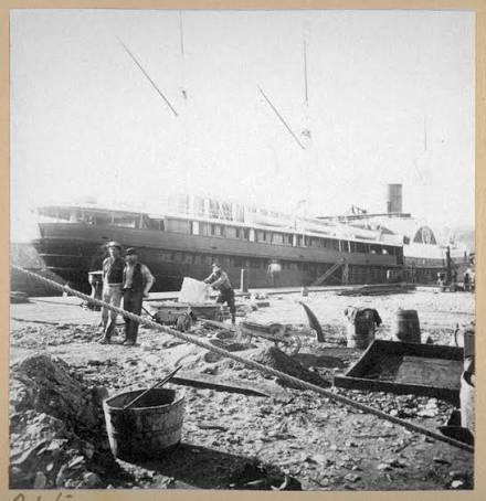 Period photograph of a Pacific Mail sidewheel steamer at the wharf
