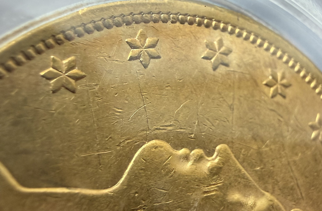 Macro view of the obverse field of an 1861 Double Eagle showing hand-cut scratches