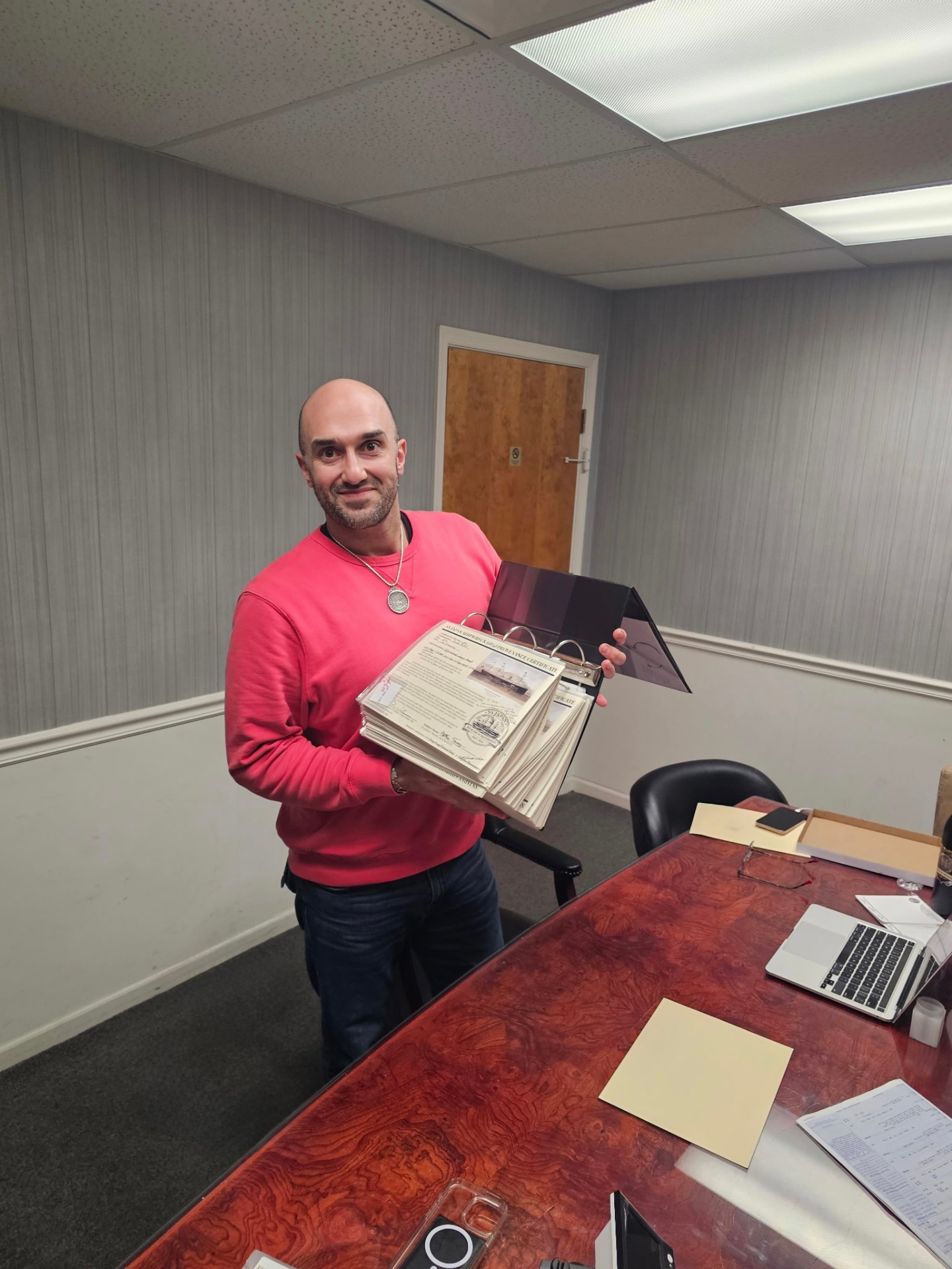 Chris Olive holding the SS Japan Provenance Certificate binder