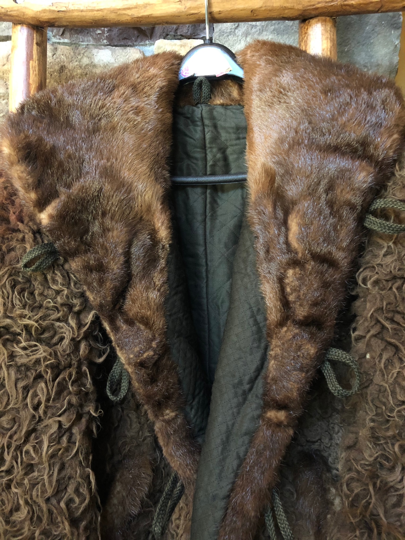 Interior view showing dark green quilted lining and frog loops