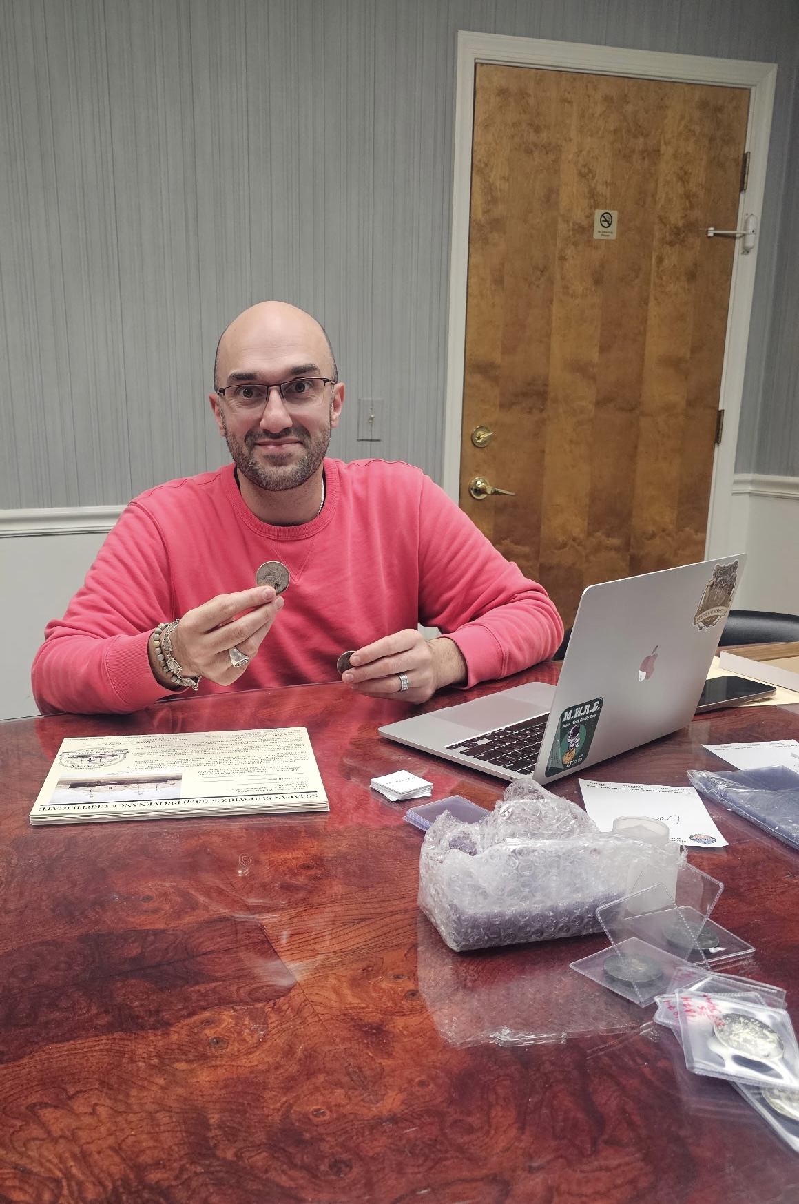 Chris Olive holding an SS Japan Trade Dollar